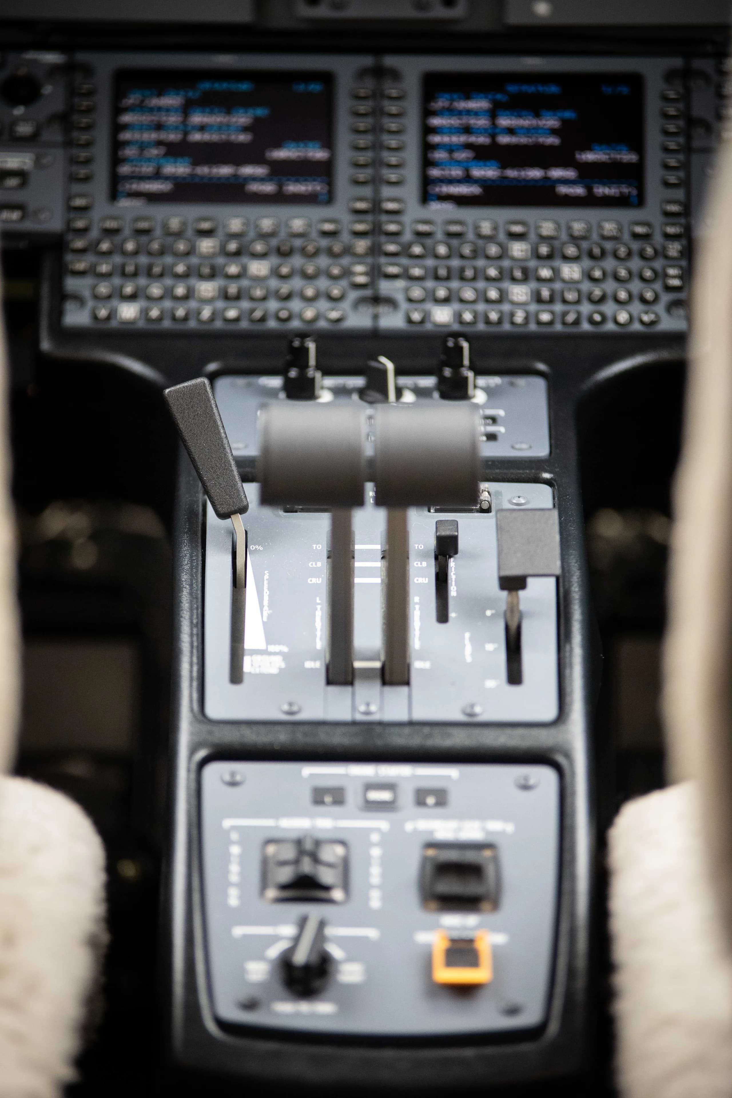 An overhead view of an aircraft's throttle quadrant and lower control panels.