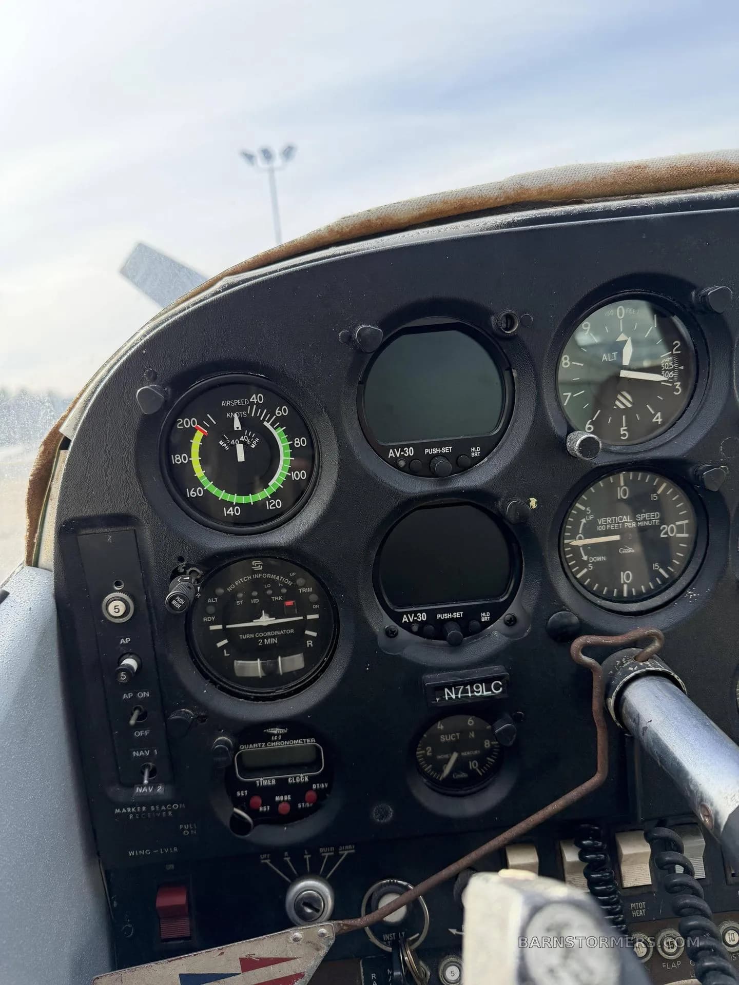 A close-up of an aircraft instrument panel showing the airspeed indicator, altimeter, and other gauges.