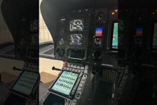 The helicopter's cockpit features modern avionics and displays.