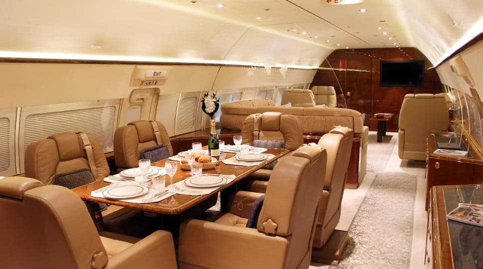 A dining area inside the aircraft cabin with a fully set table.