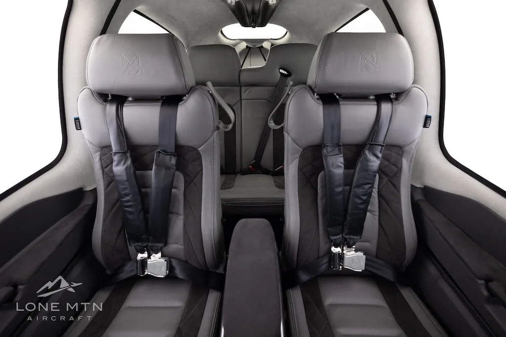The gray and black quilted front and rear seats of the Cirrus SR22T aircraft cabin.
