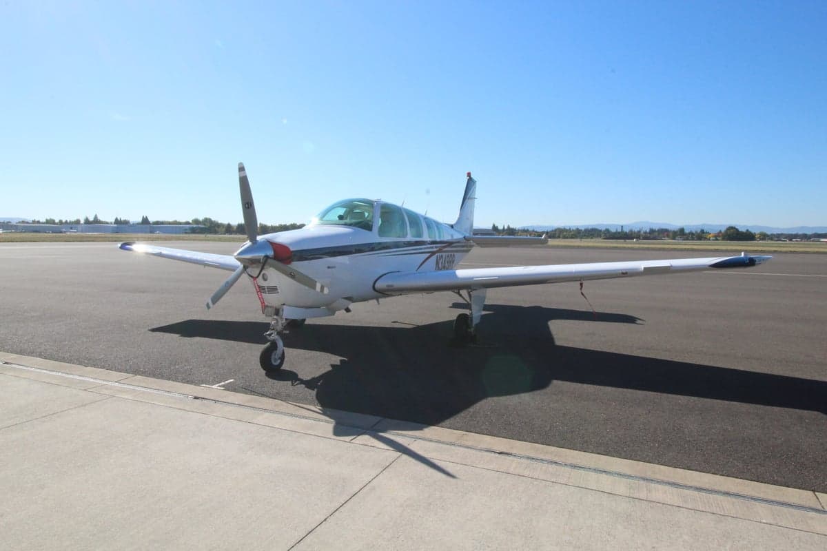 Front view of a Beechcraft Bonanza aircraft with registration N349DD on the tarmac.