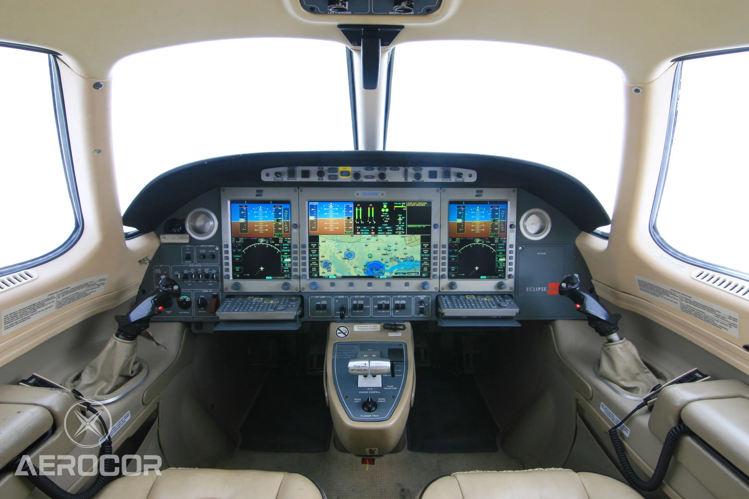 The cockpit of an Eclipse 500 jet with multiple digital displays and controls.