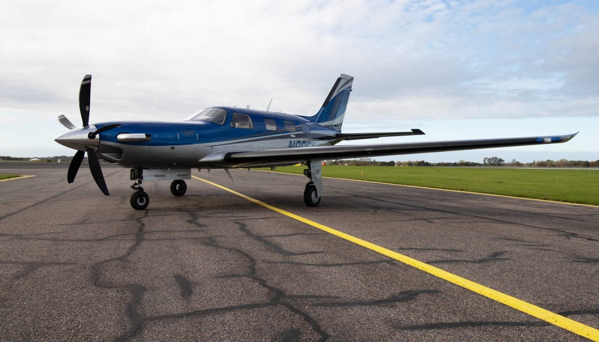 N80FY Piper M600 parked inside a hangar with a blue and silver paint scheme.