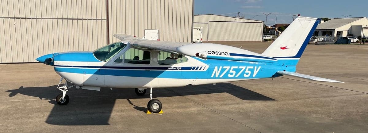 A Cessna Cardinal RG, registration N7575V, parked on the tarmac with a blue and white paint scheme.