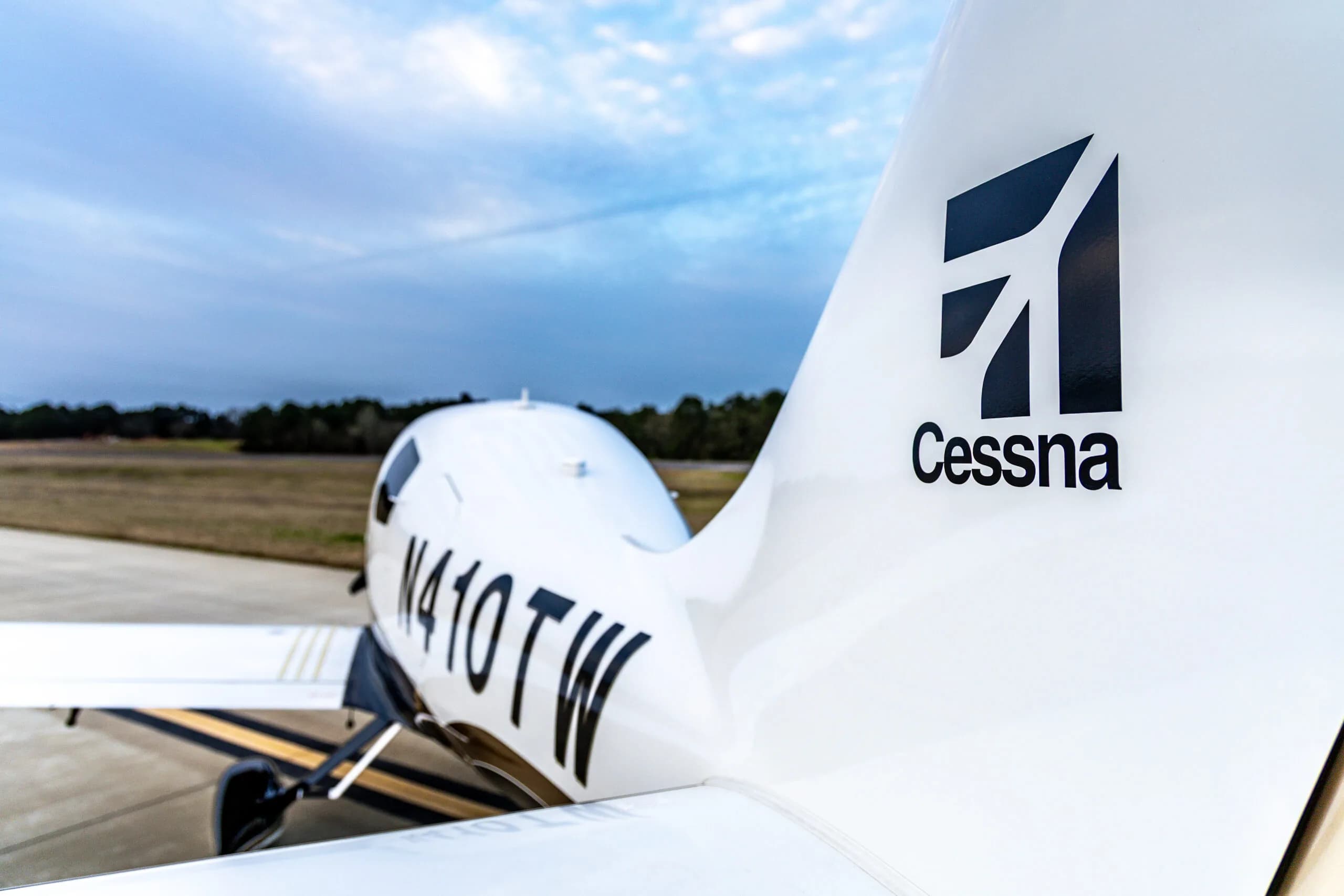 Close-up of the tail of a Cessna 400, registration N410TW, parked on the tarmac.