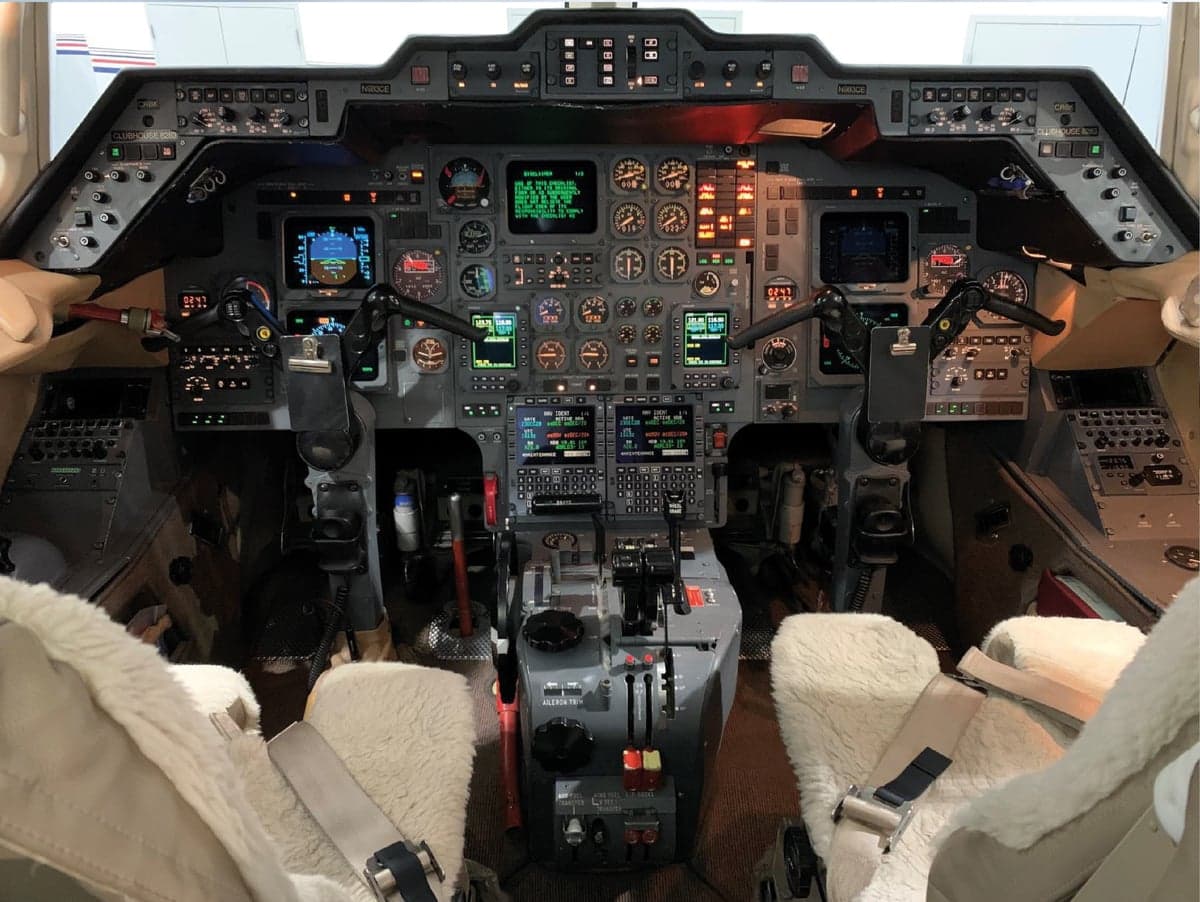 View of the aircraft cockpit with instrument panel and seats.