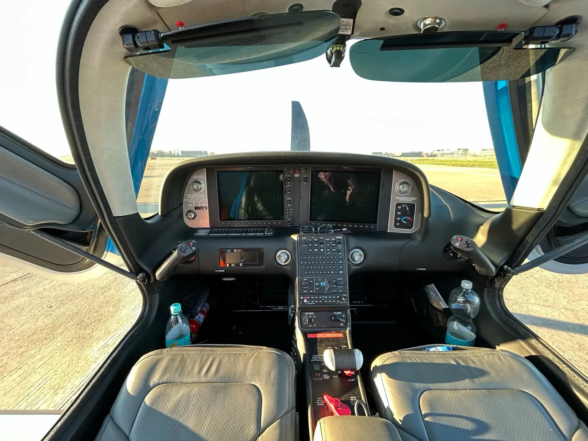 The cockpit of a Cirrus SR22, featuring dual large display screens and a central control panel.