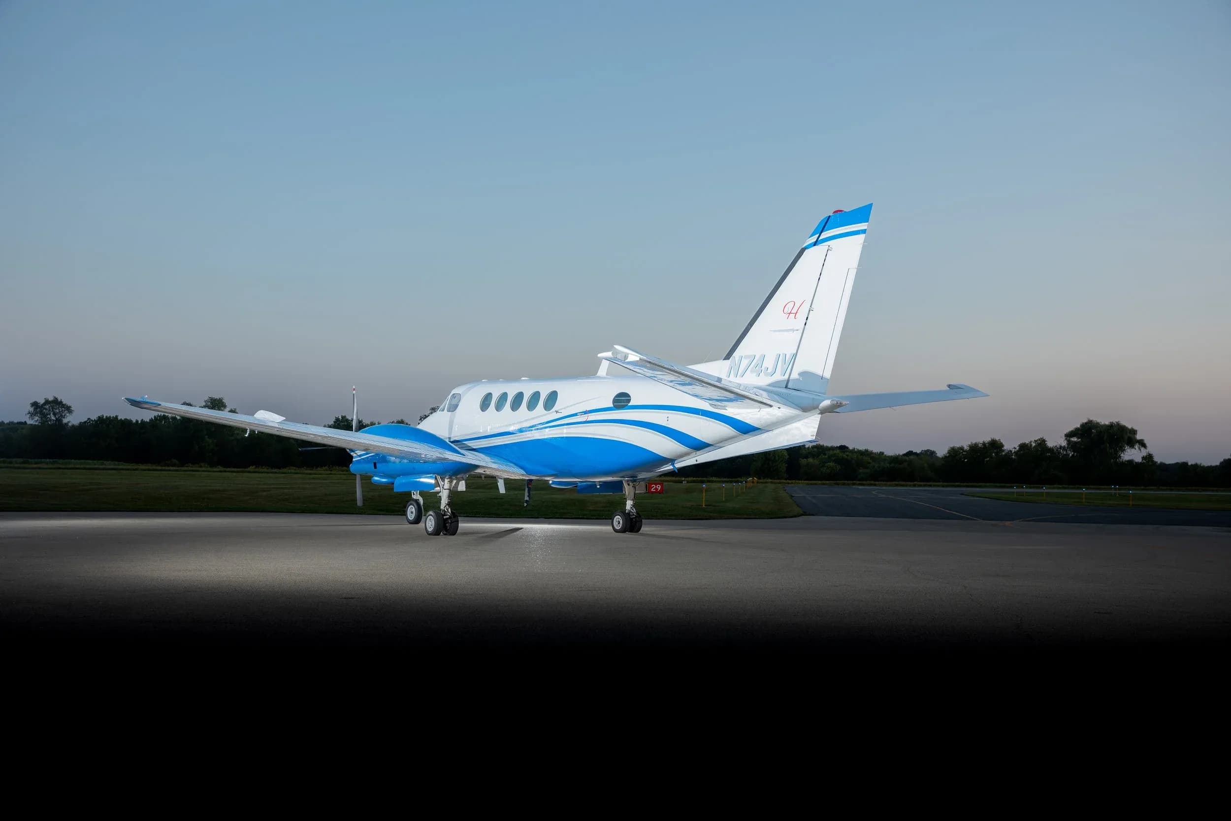 Beechcraft King Air 350i on the tarmac at sunset.