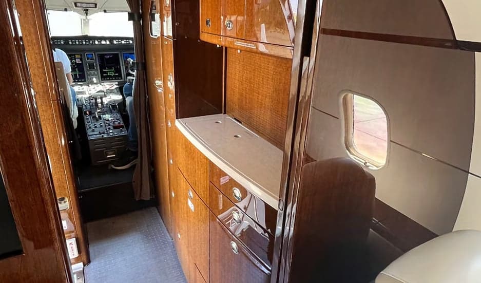 View of the aircraft interior showing the cockpit and galley area.