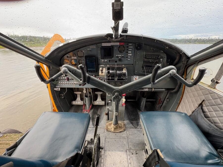 View of the aircraft cockpit with the water visible through the windshield.