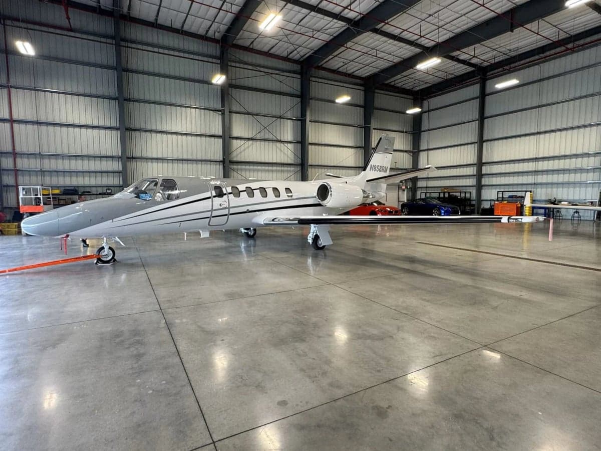Side view of a Cessna Citation CJ3, registration N858RM, inside a hangar.