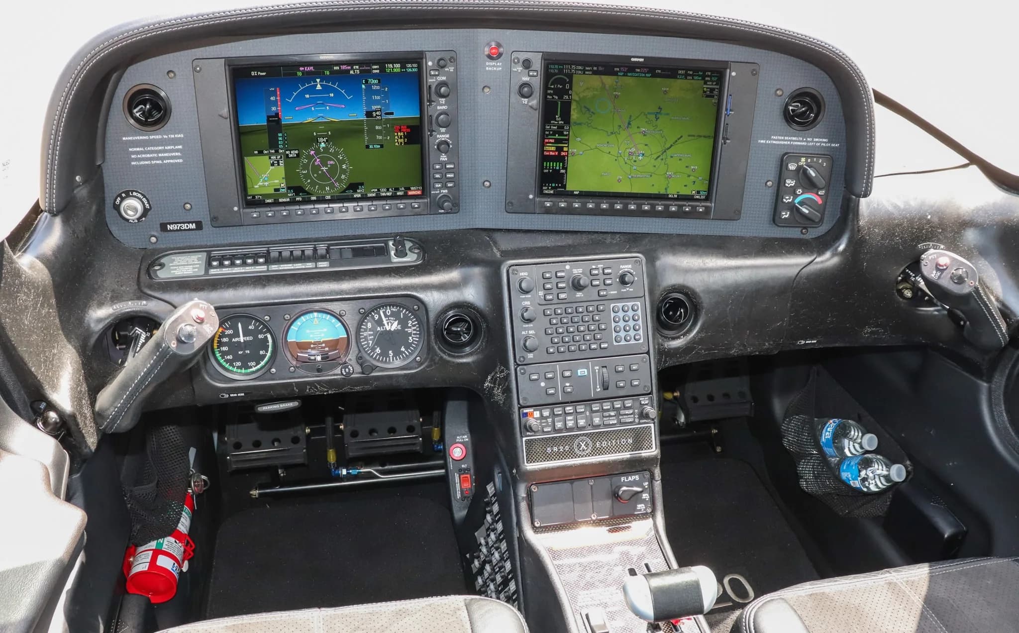 A detailed view of the Cirrus SR20 cockpit with dual Garmin G1000 displays and controls.
