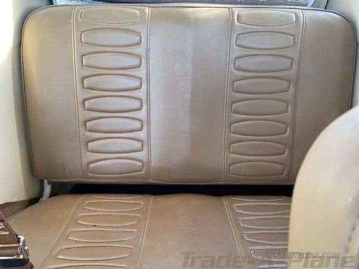 Tan vinyl aircraft seats with a distinctive ribbed pattern.