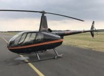 Robinson R44 Raven II helicopter on the tarmac.