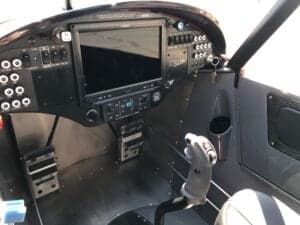 Interior view of the Cubcrafters XCub cockpit, showing the instrument panel and control stick.