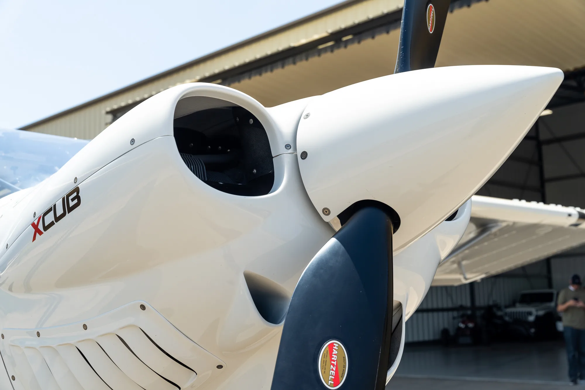 Close up of the propeller and engine cowling of a white CubCrafters XCub.