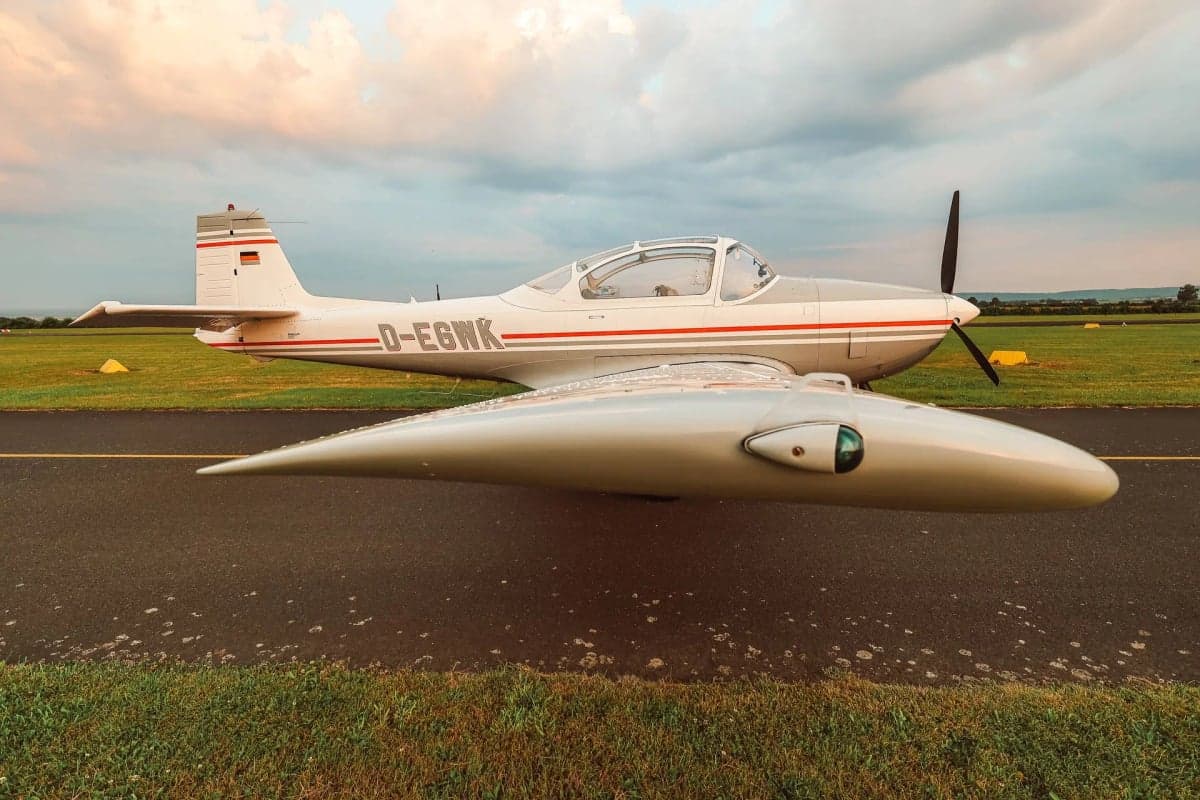 The D-EGWK aircraft is parked on the runway with a gray and white paint scheme.
