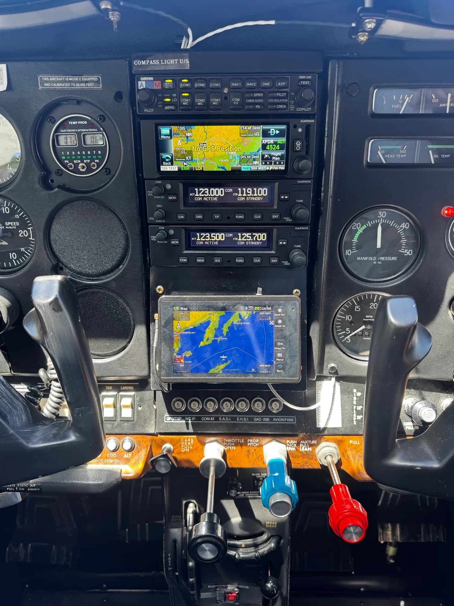 A close-up view of the Cessna Skylane instrument panel, featuring Garmin avionics and traditional gauges.