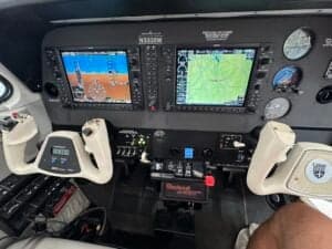 Detailed view of the aircraft's instrument panel with dual screens.