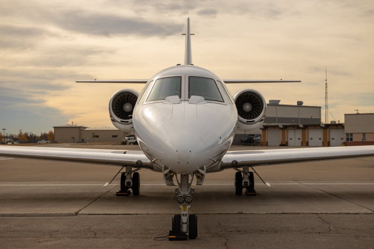 Front view of a jet aircraft on the tarmac.