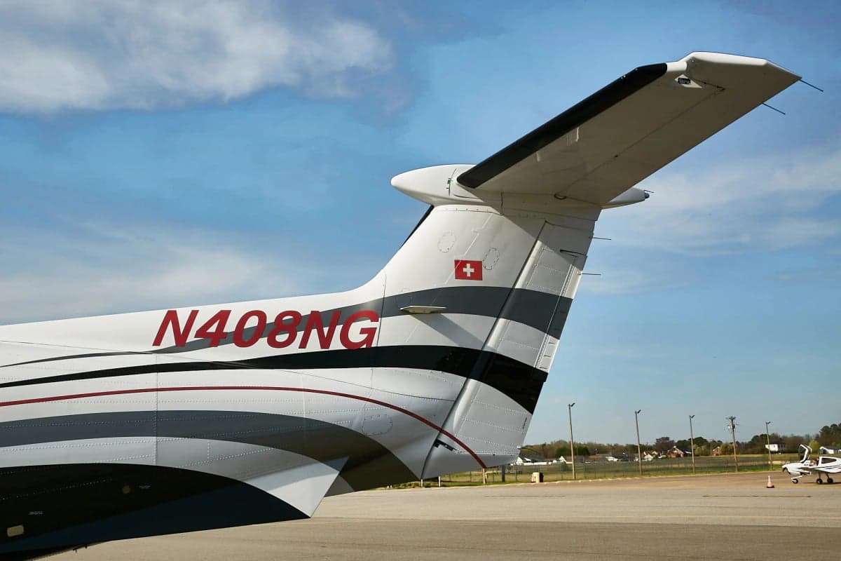 Close up of the tail of a Pilatus PC-12NG on the tarmac.