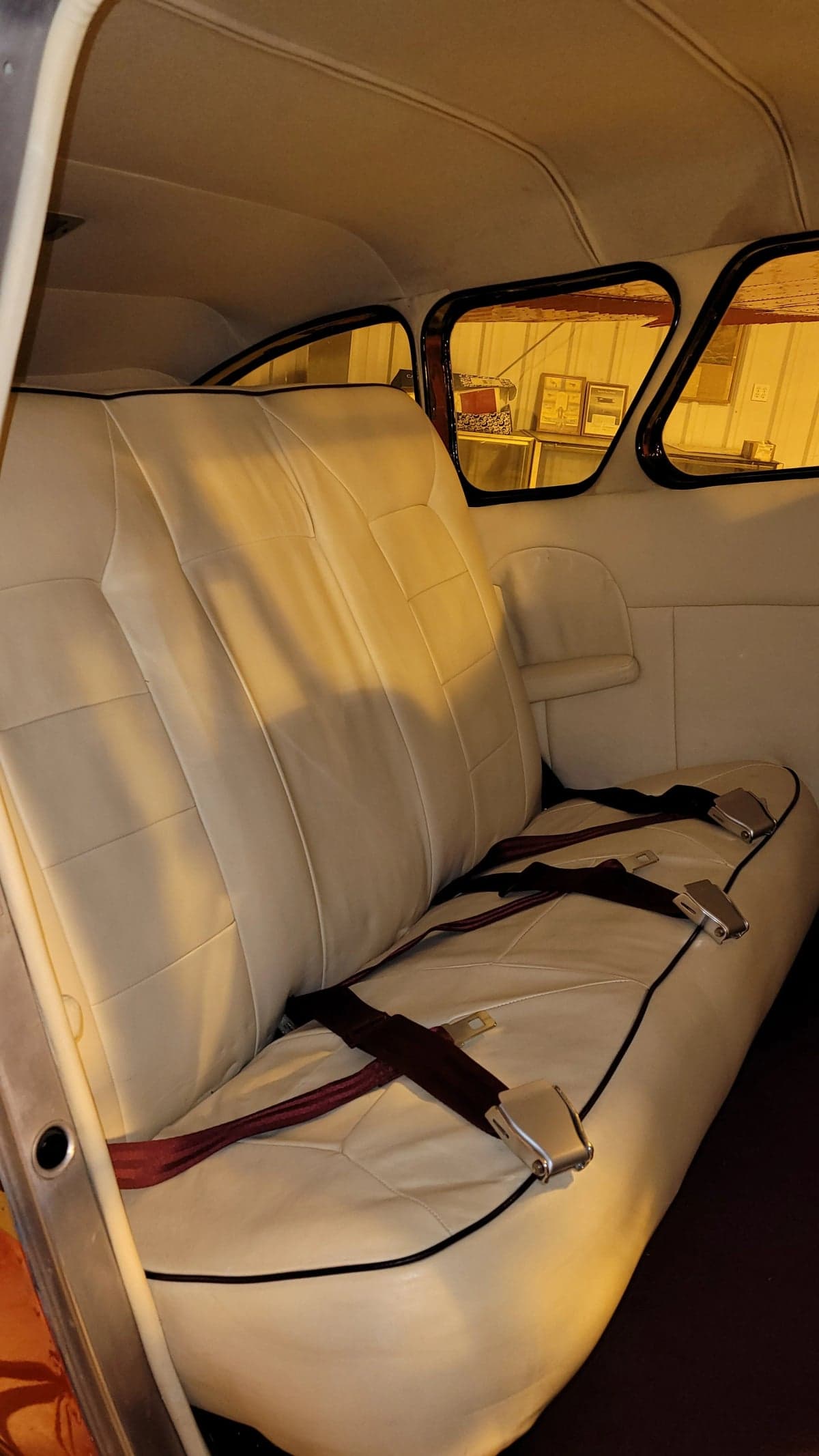 Rear bench seat in the Cessna 195 cabin.