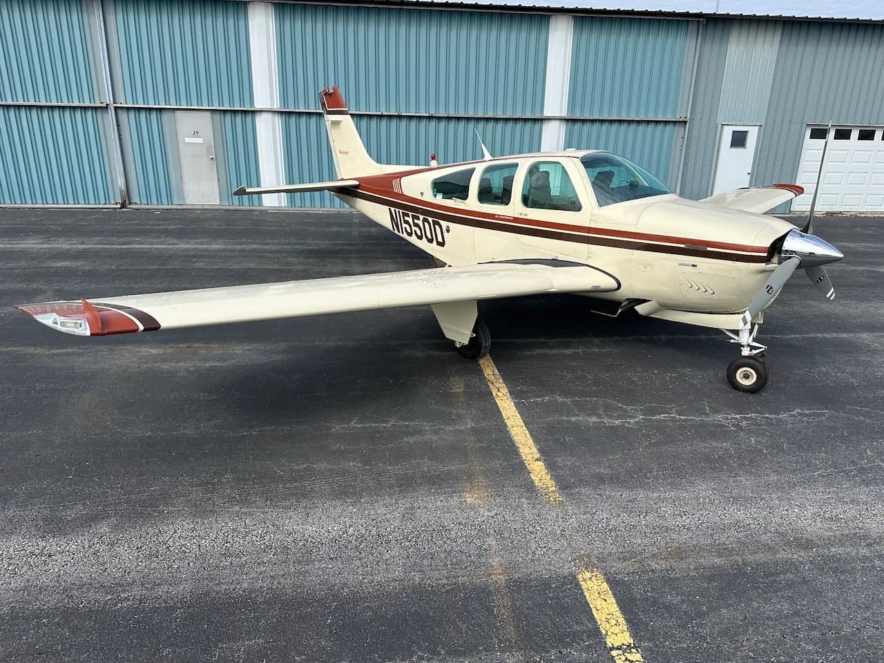 Side view of a Beechcraft Bonanza N1550D on the tarmac.