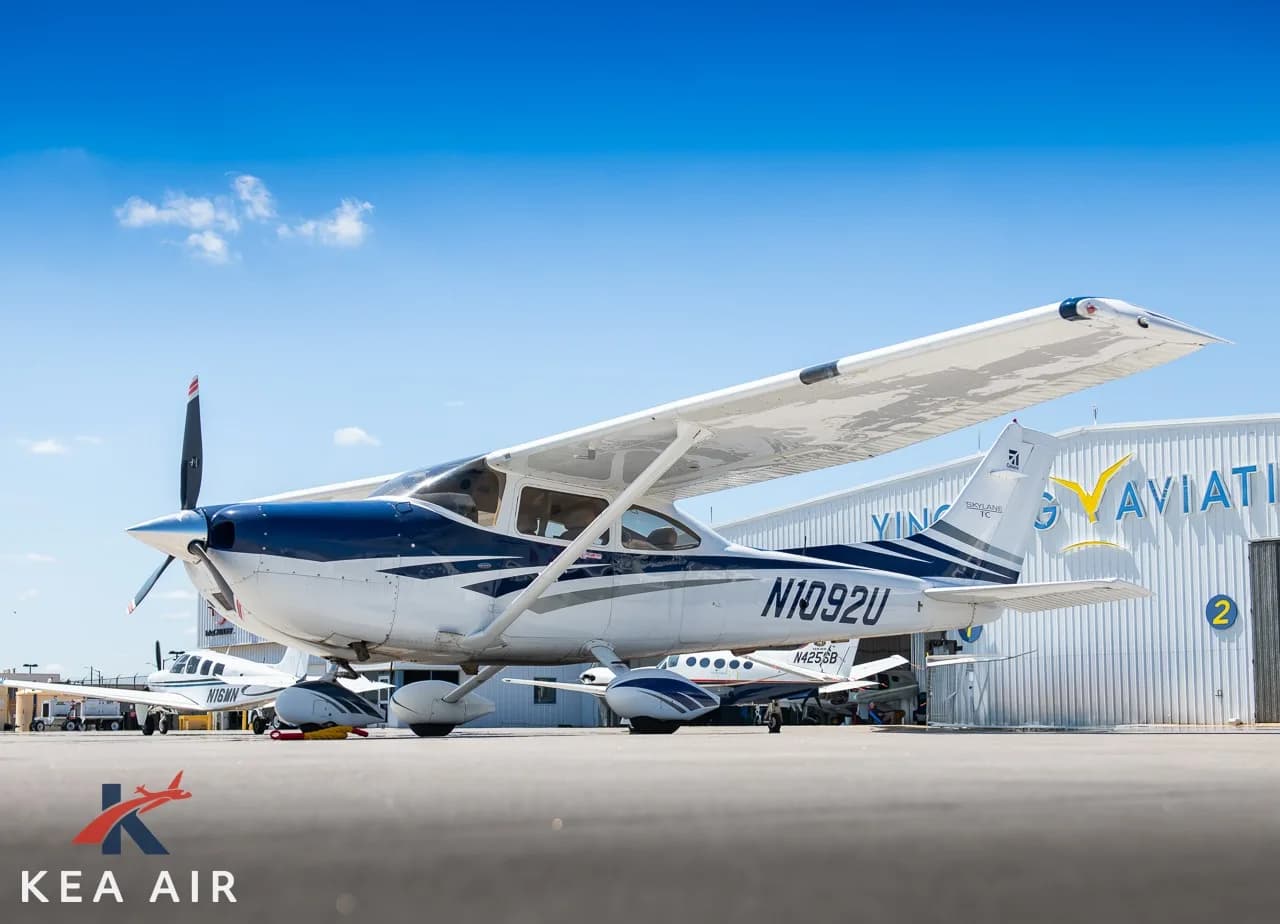 Cessna 182 Skylane with blue and white paint scheme parked on the tarmac.