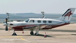 A Piper PA-46-500TP Meridian aircraft with a white and red paint scheme parked on the tarmac.