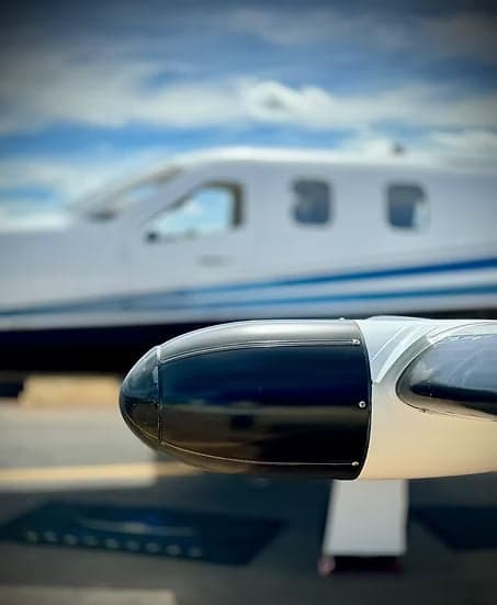 Close-up of a turboprop aircraft wing and engine nacelle, with the fuselage visible in the background.