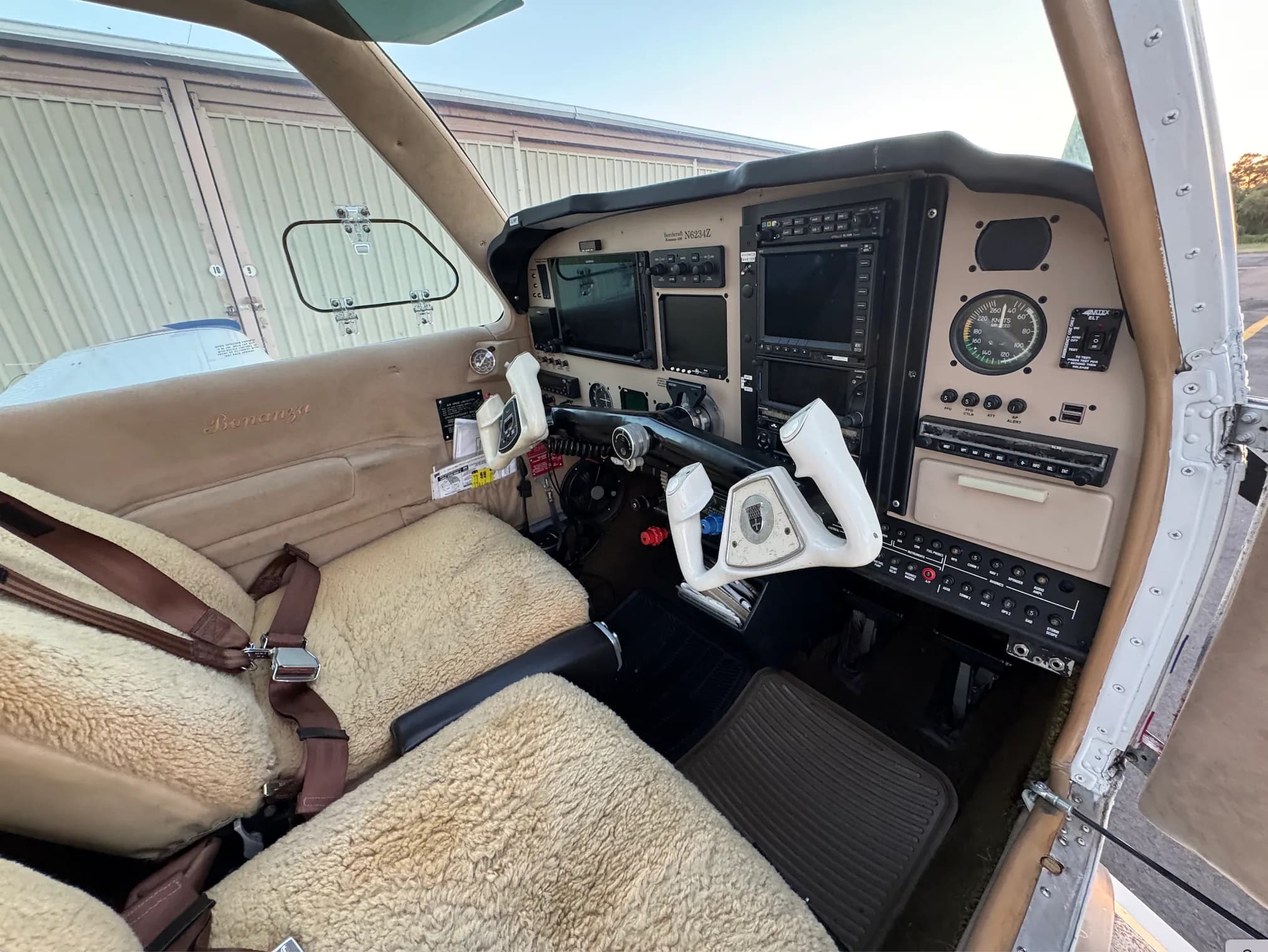 Interior view of the Beechcraft Bonanza cockpit with sheepskin seat covers.