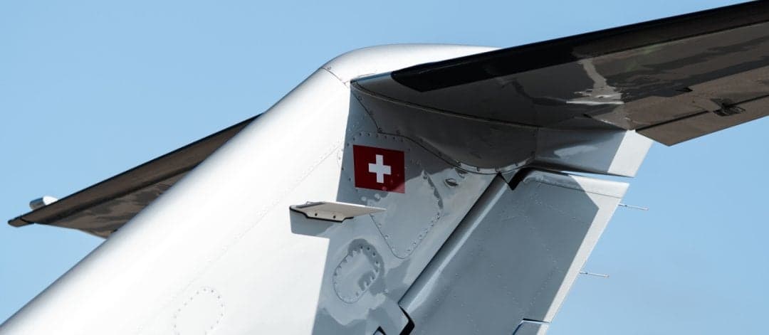 Close-up of the tail of the aircraft with the Swiss flag.