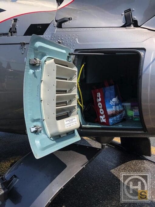 Open storage compartment on the side of the helicopter.