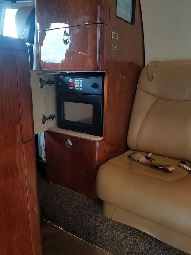 Interior view of the aircraft with a seat and a microwave.