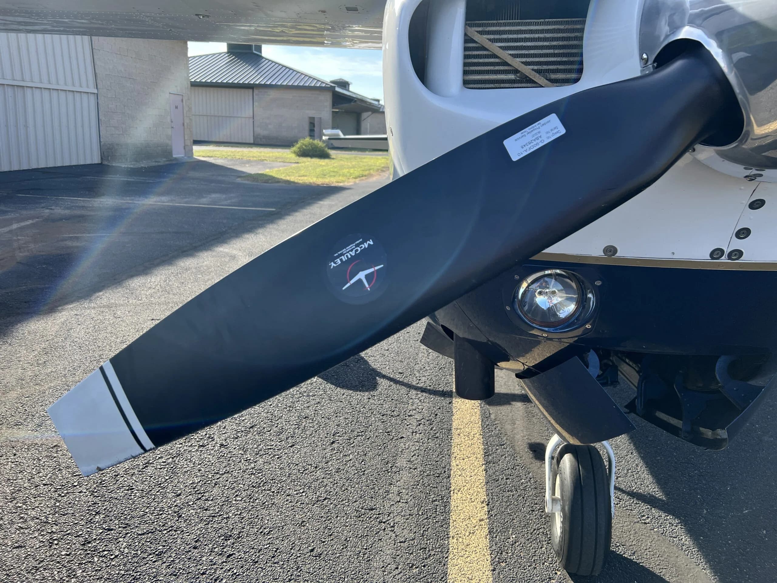 A close-up of the McCauley propeller and nose landing gear of the Cessna 210, N58MA.