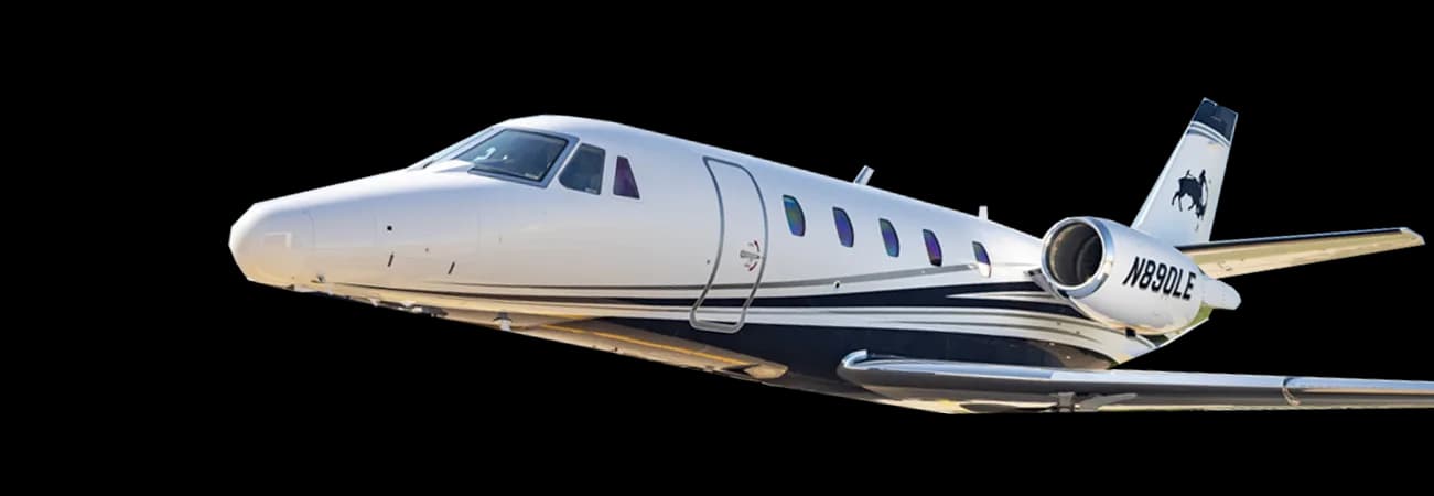 A white and blue Cessna Citation XLS with registration N89DLE against a black background.