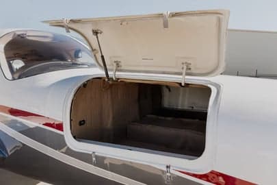 Side view of Beechcraft aircraft N878DM parked on the tarmac.