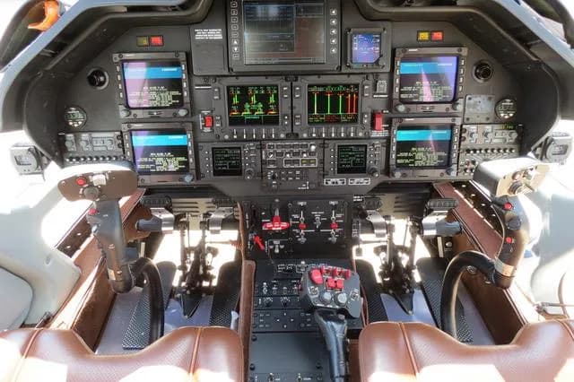 The cockpit of an AgustaWestland AW109 GrandNew helicopter, showing the instrument panel and controls.