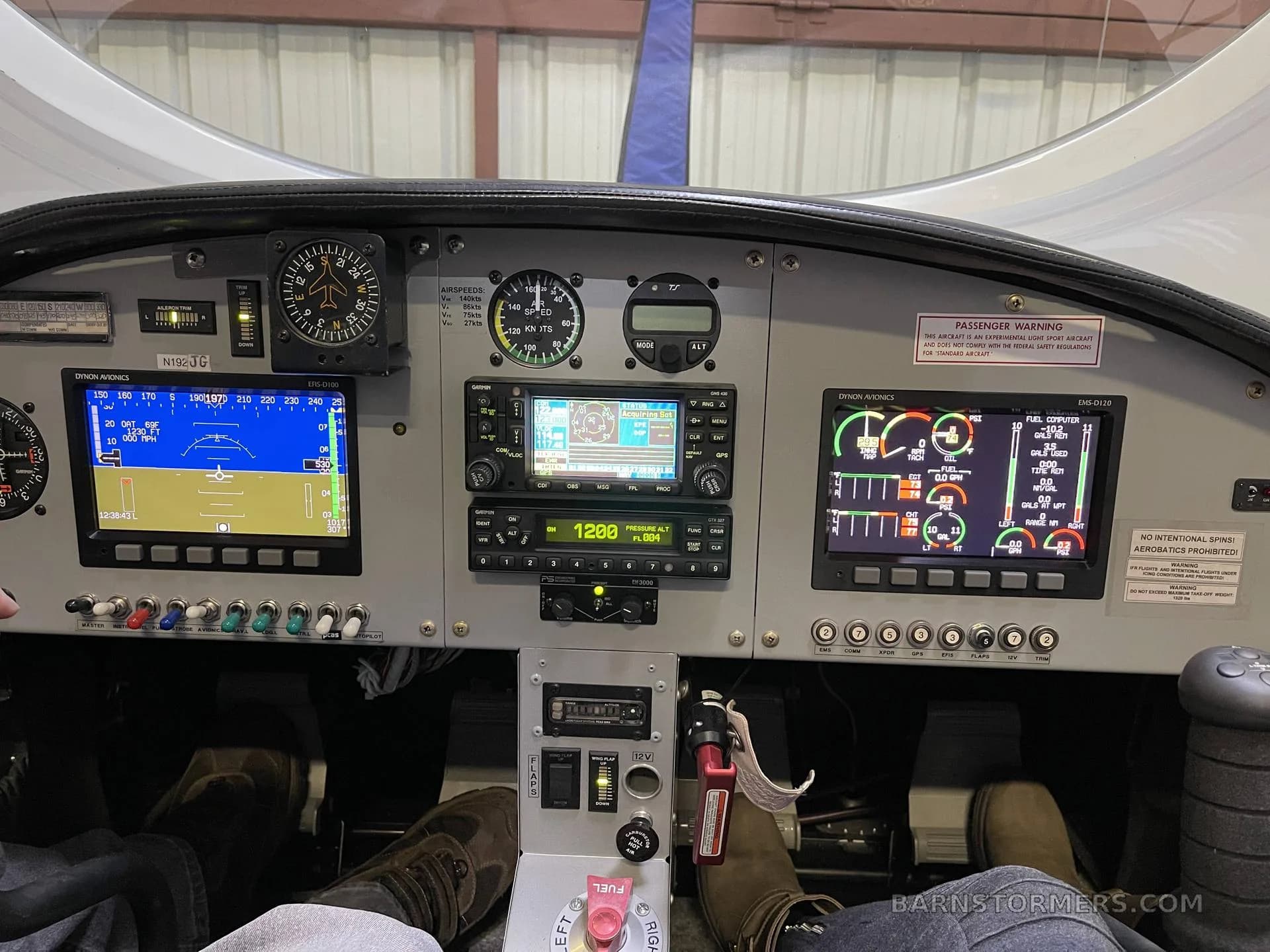 A detailed view of a modern aircraft cockpit with multiple digital displays and analog gauges.