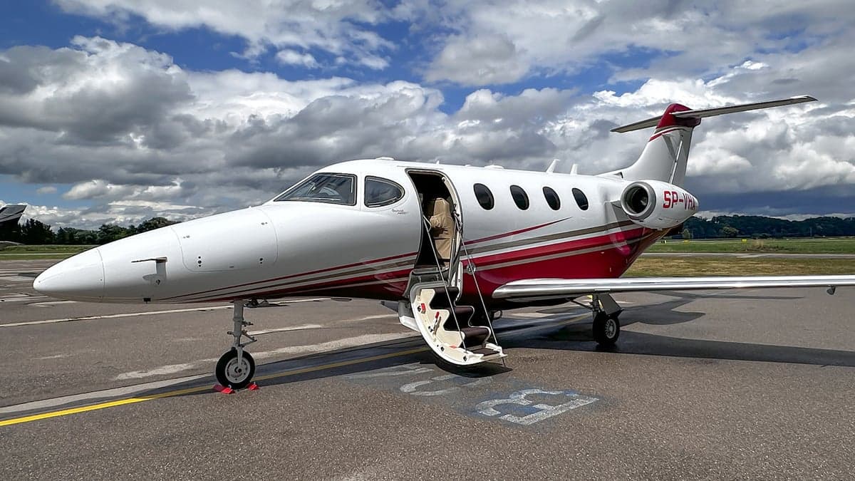 SP-VHA aircraft parked on the tarmac with the door open.