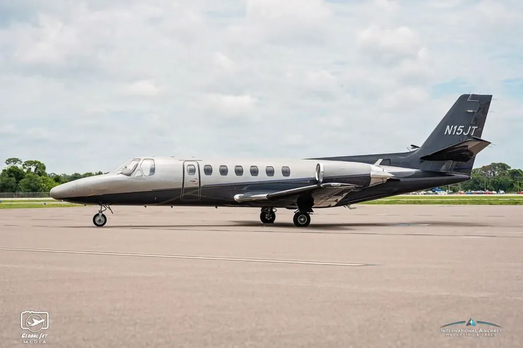 The N15JT Cessna Citation X business jet is seen from the side on an airfield.