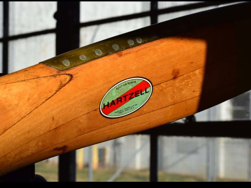 Close-up of a wooden propeller with a Hartzell logo.