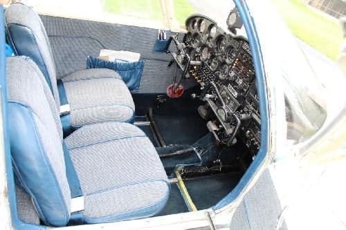 Interior view of the aircraft cabin showing the seats and instrument panel.