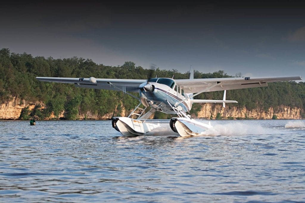 A Cessna Caravan seaplane on the water.