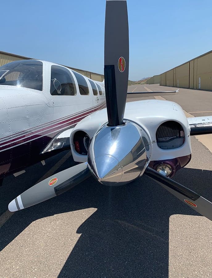 Close-up of the propeller and nose of the N3871C aircraft.
