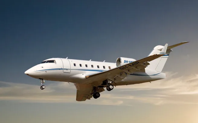 Challenger aircraft in flight with landing gear down.