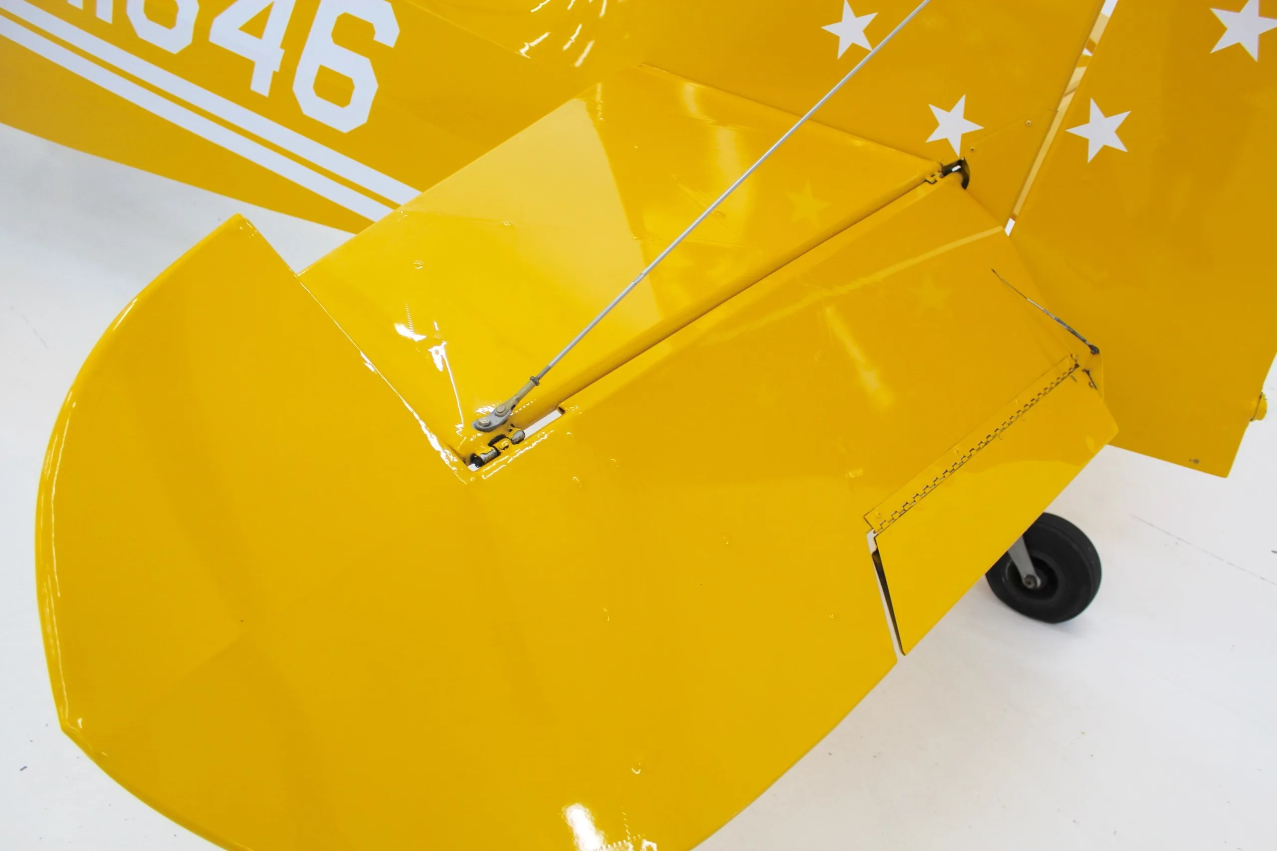 A close-up view of the yellow horizontal stabilizer and elevator of the N11646 aircraft.
