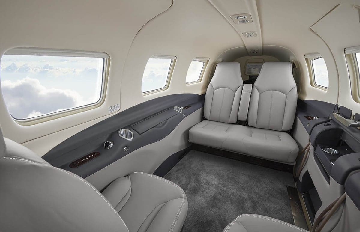 View of the aircraft cabin with gray leather seats.