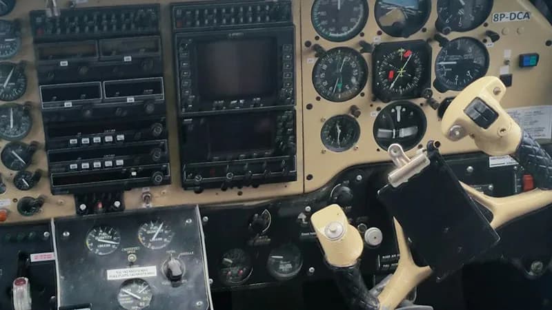 Cockpit instrument panel with various gauges and controls.